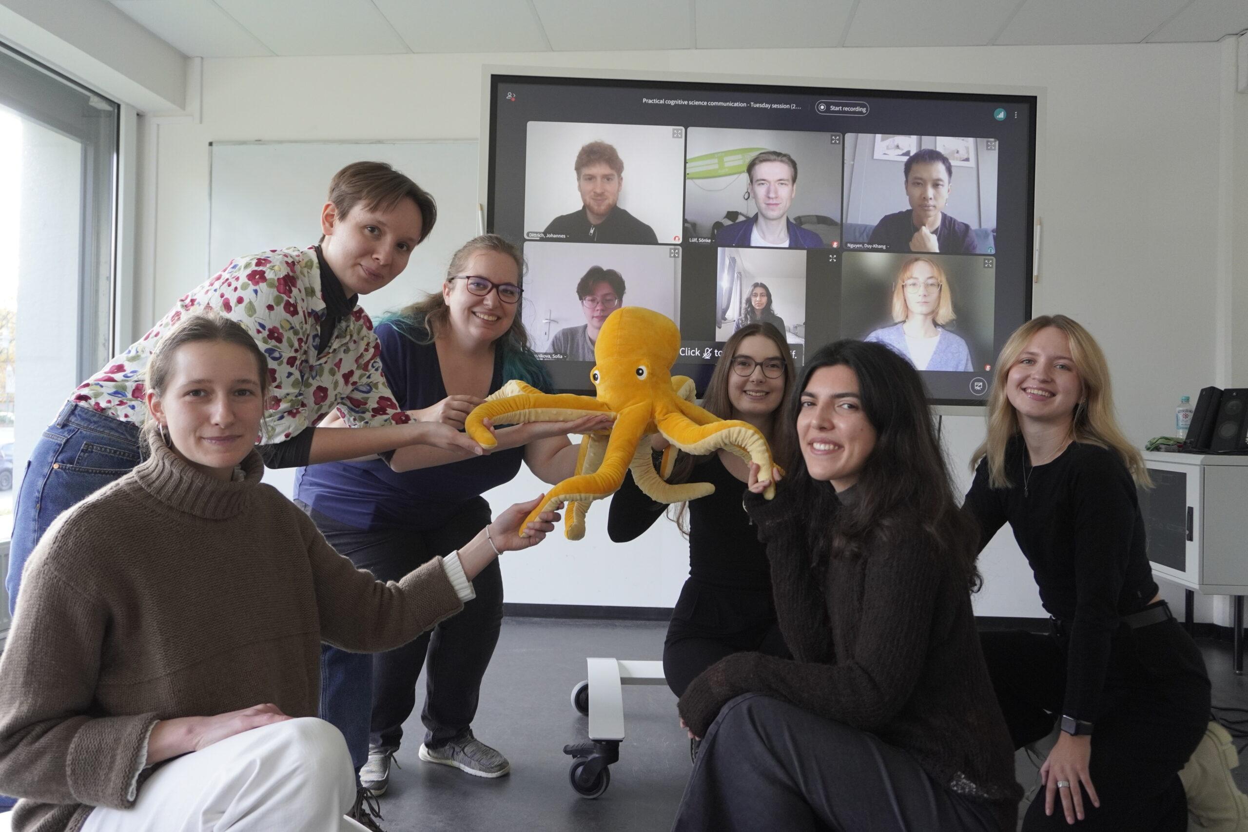 Picture of the student journal members from the winterterm 23/24 with the octopus in the middle.